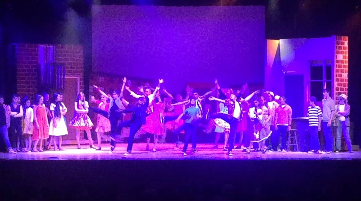 A full cast on stage — one of the hundreds of productions Erin has directed